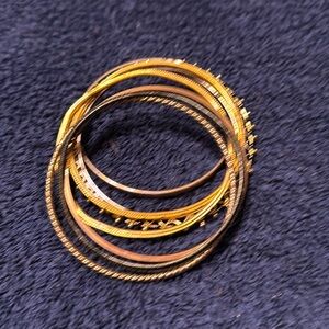 Bundle of gold and black bracelets.